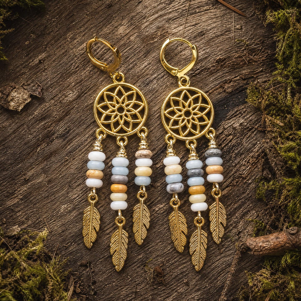 dreamcatcher earrings with amazonite beads and feather details on a wooden surface